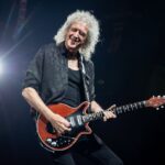 Brian May on stage palying guitar