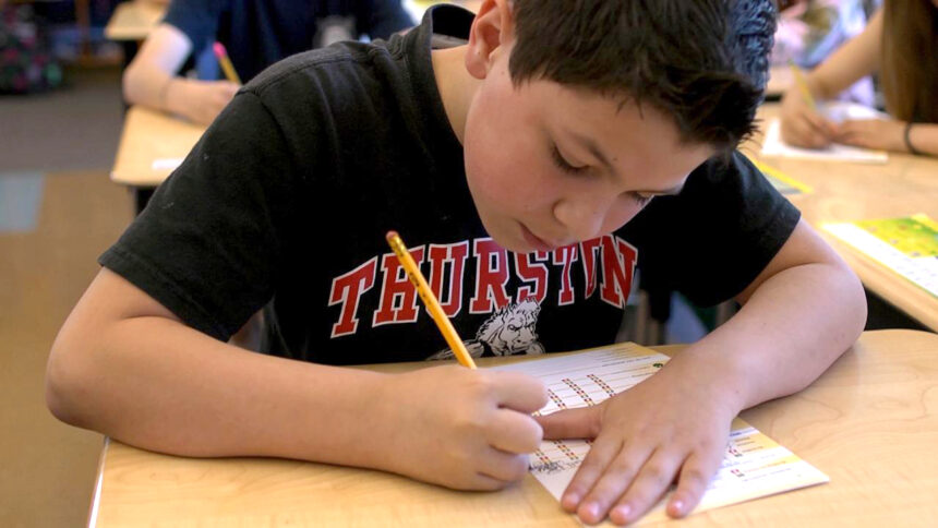 Picture of a boy filling out a We Have Choices daily tracker to monitor his self-regulation skills