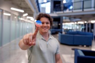 Student with sticker to teach the 2024 election