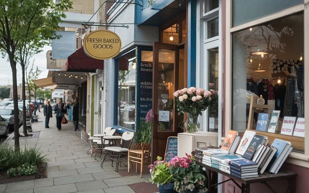 A morning on a city street with shops open and books out on displey.