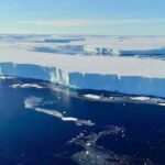 A huge block of ice floats in the water