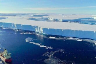 A huge block of ice floats in the water