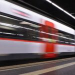 A subway train rolls into a station in Barcelona.