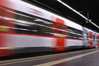 A subway train rolls into a station in Barcelona.