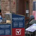 A poll worker collects mail in ballots from a drop box for the New Jersey primary election on June 4, 2024, in Hoboken, New Jersey