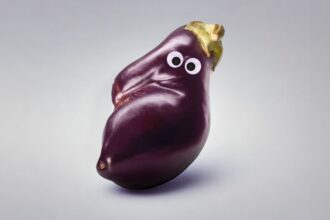 An eggplant with googly eyes