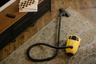 Yellow canister vacuum on a rug