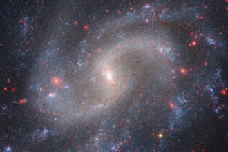 A spiral galaxy shown in a composite image from the James Webb Space Telescope and Hubble Space Telescope