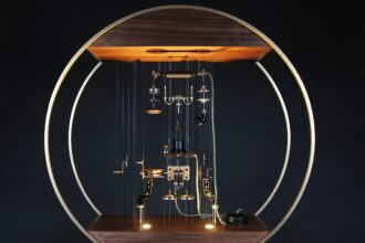 a sculpture made from a historic "Eiffel Tower" telephone that has been taken apart into every component and suspended on monofilament