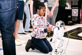 A girl with a robot at New Scientist Live