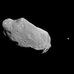 Black and white image of the asteroid Ida and its moon Dactyl