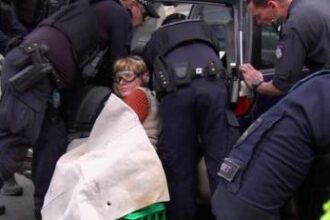 Woman sets hand in concrete as Melbourne protest continues