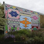 a mural depicting colorful Ndebele shapes and patterns outlined with a black border