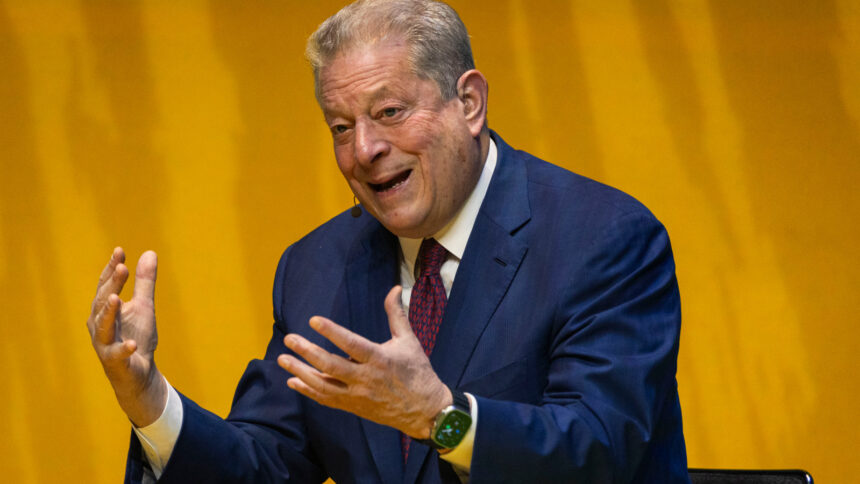 Photo of Al Gore talking with passion in front of an orange background