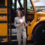 Vice President Kamala Harris walks off of an electric school bus.