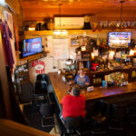 A bartender and patron chat at The Hollow Bar & Grill in Montfort, Wisconsin, on Oct. 10. The sports bar is one of few businesses in the small town.