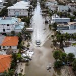 Aerial of car droving through flooded street