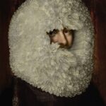 a digitally reimagined portrait showing a man with a lace ruff that ridiculously covers his head and his face