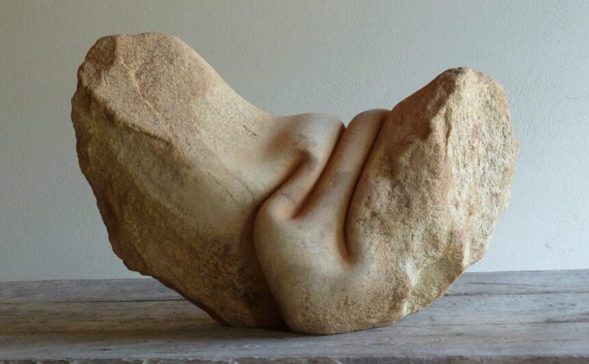 a sculpture made from stone that has been carved to appear as though it is wrinkled like fabric or skin on the top