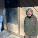 Byrdene Byerly, who lost her home in Yancey County from floods caused by Hurricane Helene, stands outside a polling place after voting for Kamala Harris.