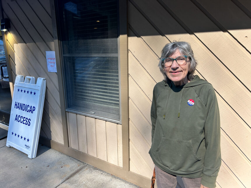 Byrdene Byerly, who lost her home in Yancey County from floods caused by Hurricane Helene, stands outside a polling place after voting for Kamala Harris.