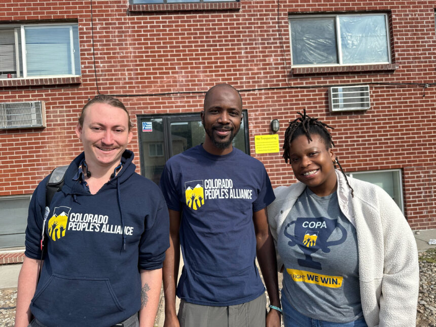 Julian Temianka, Lamine Kane and Jojo Franklin, organizers at Colorado People’s Alliance, stand outside the apartment complex in Aurora, Colorado, that former President Donald Trump has said is gang riddled, on Oct. 11.