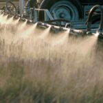 A machine sprays pesticides over a field.