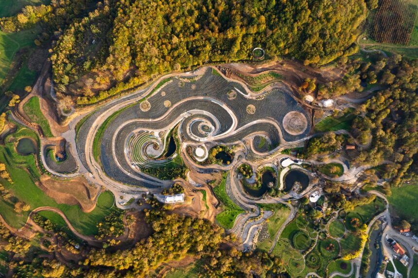 an aerial view of an elaborate hillside garden and landscape design inspired by the curling forms of Vincent van Gogh's painting, "The Starry Night"