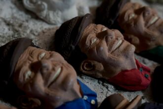 Bolivian Artist Carves Faces On Bread For Day Of The Dead