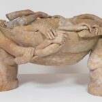 fragmented arms and hands appear to conjoin and hold up a terracotta bowl