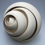 a ceramic sculpture with concentric forms that twist and well outward