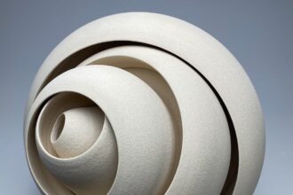 a ceramic sculpture with concentric forms that twist and well outward