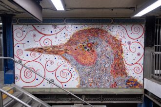 a mosaic mural of a bird in a New York City subway station