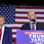 Bazzi speaks beside Trump at a campaign rally Oct. 26 in Novi, Michigan.