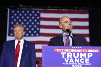 Bazzi speaks beside Trump at a campaign rally Oct. 26 in Novi, Michigan.