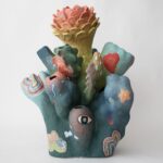 an abstract, colorful ceramic sculpture with nature-inspired elements evocative of coral or flowers