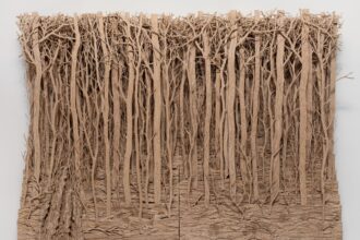 a cardboard wall work of a densely carved forest. All images courtesy of Mariane Ibrahim, shared with permission