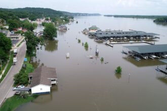 A small town is inundated by brown flood waters