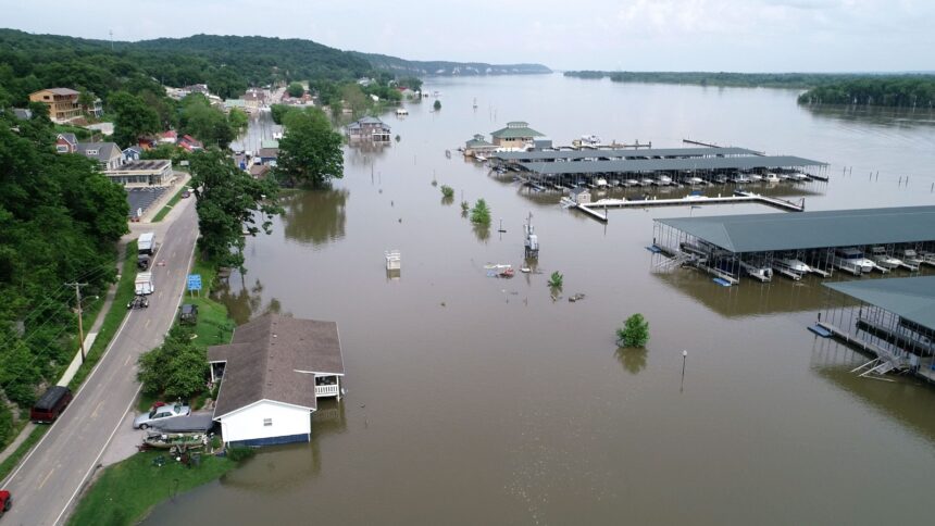 A small town is inundated by brown flood waters