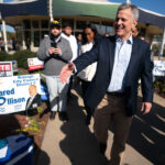 North Carolina Democratic candidate for governor, Josh Stein, reaches out to shake hands outside of a polling location on Election Day at John Chavis Memorial Park in Raleigh, North Carolina, on Nov. 5.