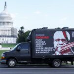 A billboard truck calling for Justice Clarence Thomas to recuse himself in the case that eventually overturned the Chevron Doctrine passes in front of the US Capitol building in 2023, before the case was heard.