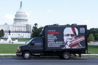 A billboard truck calling for Justice Clarence Thomas to recuse himself in the case that eventually overturned the Chevron Doctrine passes in front of the US Capitol building in 2023, before the case was heard.