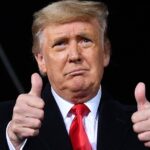 Then-President Donald Trump holds two thumbs up at a campaign rally for incumbent Sens. Kelly Loeffler and David Perdue ahead of Senate runoff in Dalton, Georgia on Jan. 4, 2021.