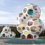 colorful hexagon windows fit into white bubbly structures on a playground