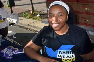 A woman at a voting information booth.