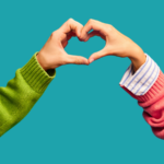 Photo of two hands creating a heart during a teacher pep talk