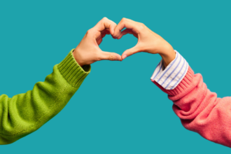 Photo of two hands creating a heart during a teacher pep talk