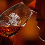 A whiskey drinker savors the aromas in a glass.