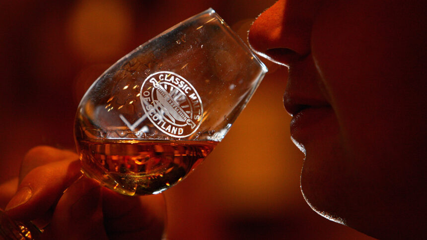 A whiskey drinker savors the aromas in a glass.