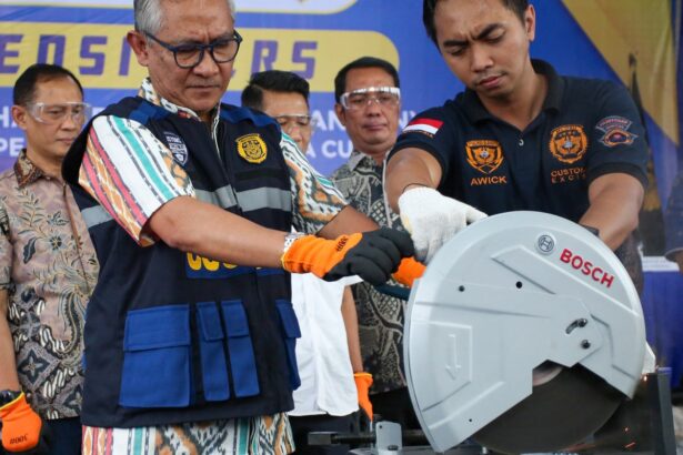 Indonesian customs officials destroy a smuggled iPhone 16 Pro Max that was confiscated alongside dozens of Apple phones and tablets, at the customs office of SoekarnoHatta International Airport in Tangerang, Banten, on November 29, 2024.